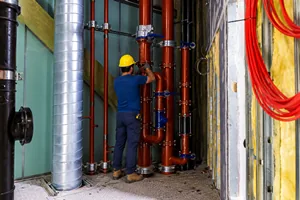 Técnico trabalhando em prumada predial